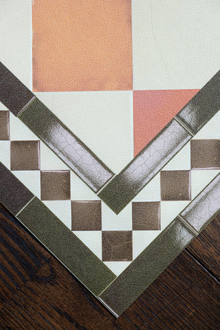 The corner detail of the Terracotta Checkered Durable Floor Mat, showing the tile-effect border. 