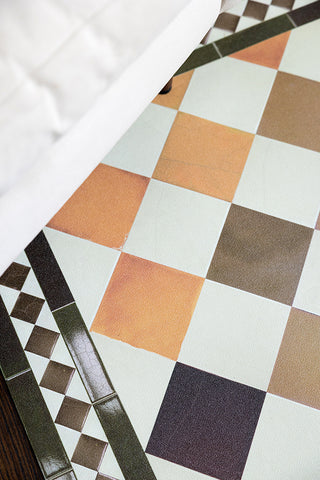 The corner detail of the Terracotta Checkered Durable Floor Mat, showing the earthy colour palette. 