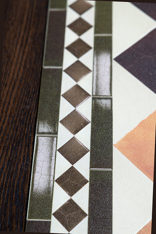 The outside edge of the Terracotta Checkered Durable Floor Mat, showing the tile-effect border. 