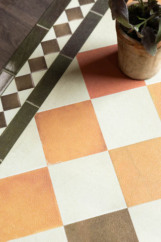 A detail shot of the Terracotta Checkered Durable Runner, showing the colours and checkered pattern. 