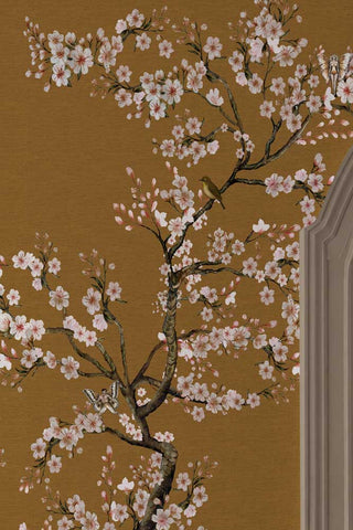 The Blossom Mischief Mural Wallpaper in Antique Gold shown in more detail of the pattern.