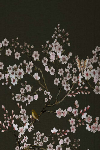 The Blossom Mischief Mural Wallpaper in Forest shown in detail where you can see the blossom, bird and winged figure within the pattern. 