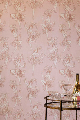 The Cha Cha Cha Wallpaper in Watermelon Blush with an antique gold bar cart in the corner. 