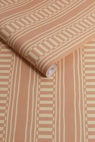 The roll of The Curiosity Shop Stripe Wallpaper in Blush.