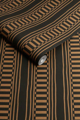 A roll of The Curiosity Shop Stripe Wallpaper in Noir. 