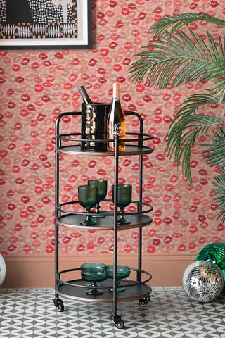 The Kiss Me Lipstick Wallpaper shown with a bar cart. 