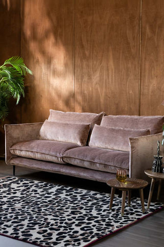 The Lola 4 Seater Sofa in Luxe Pink Velvet styled with a rug, tables and various accessories.