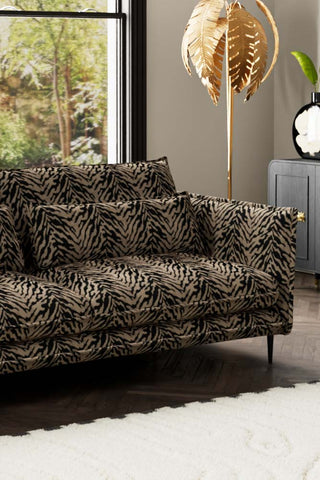 Close-up of one side of The Lola 4 Seater Sofa in Tiger Print Velvet.