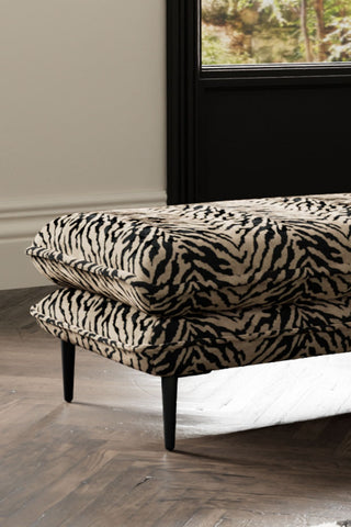 Close-up of one side of The Lola Footstool in Tiger Print Velvet.