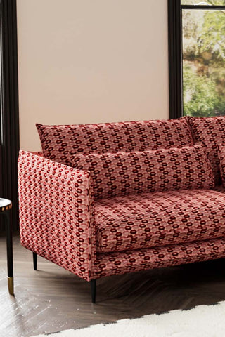 Close-up of one side of The Lola 3 Seater Sofa in Woven Red & Pink Lips Velvet.