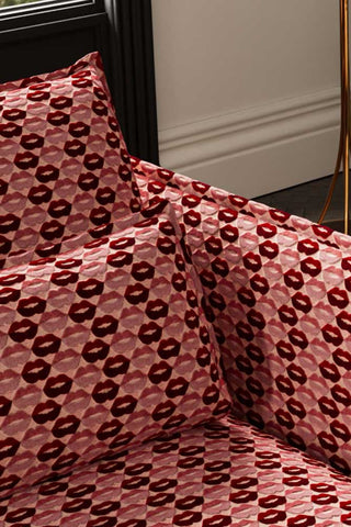 Close-up of the seat/cushions of The Lola 3 Seater Sofa in Woven Red & Pink Lips Velvet.