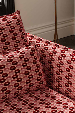 Close-up of The Lola 4 Seater Sofa in Woven Red & Pink Lips Velvet.