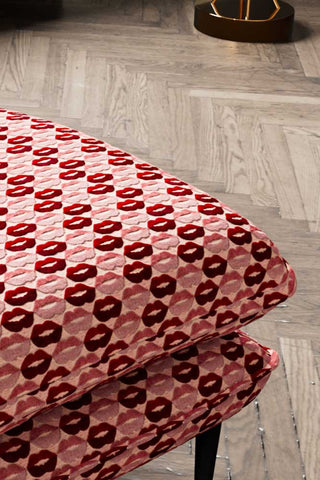 Close-up of the corner of The Lola Footstool in Woven Red & Pink Lips Velvet.