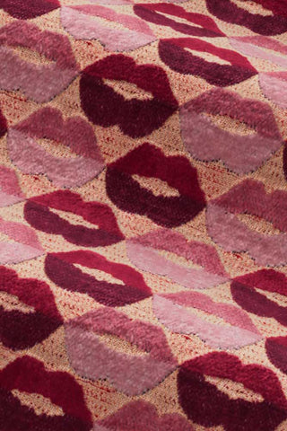 Close-up of the fabric of The Lola Footstool in Woven Red & Pink Lips Velvet.