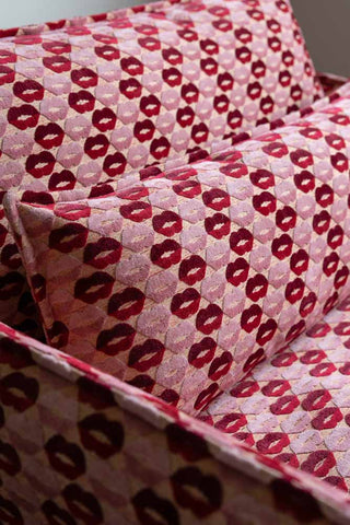Close-up of the back and cushion of The Lola Snuggle Seat in Woven Red & Pink Lips Velvet.