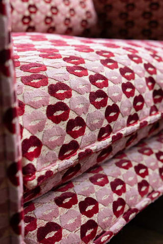 Close-up of the front of The Lola Snuggle Seat in Woven Red & Pink Lips Velvet.