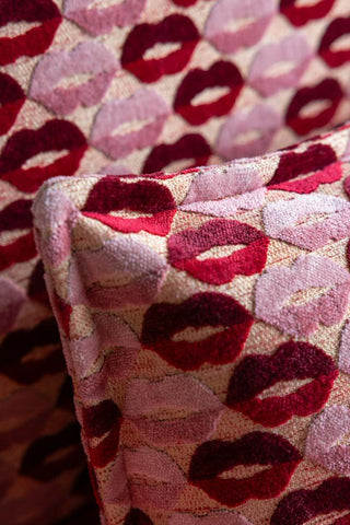 Close-up of the fabric of The Lola Snuggle Seat in Woven Red & Pink Lips Velvet.