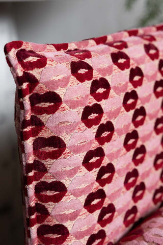 Close-up of the side of cushion from The Lola Snuggle Seat in Woven Red & Pink Lips Velvet.