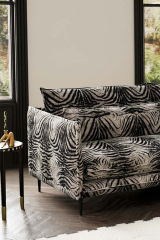 Close-up of one side of The Lola 4 Seater Sofa in Zebra Print Velvet.