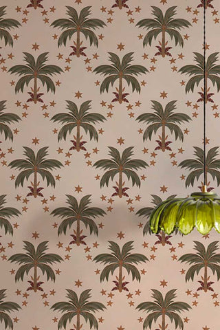 The The Midnight Palms Wallpaper in Ivory shown with a green glass ceiling light. 