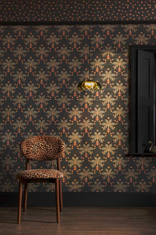 The Midnight Palms Wallpaper in Noir shown with a leopard print chair. 