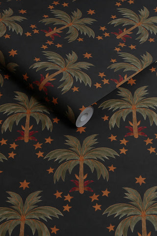 The roll of The Midnight Palms Wallpaper in Noir.