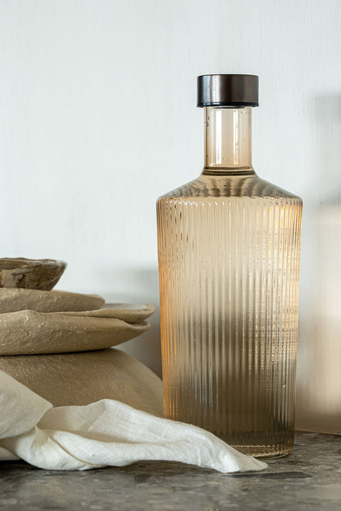 The Paveau Ribbed Glass Carafe in Amber Rockett St