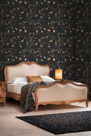 The Secret Garden Chinoiserie Wallpaper in Black Ink shown in a bedroom with a French-style bed.