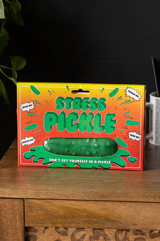 The Stress Pickle in the box, displayed on a wooden sideboard.