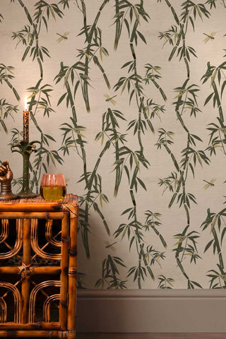 The Wham Bamboo Wallpaper in Ivory Green shown with a bamboo cabinet. 