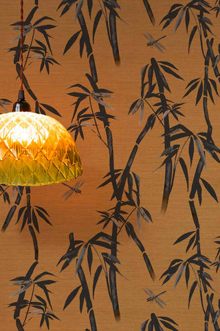 The Wham Bamboo Wallpaper in Golden Hour Noir shown with a glass ceiling light. 