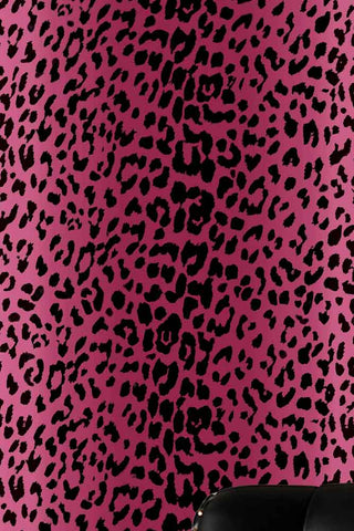 The Wild At Heart Wallpaper in Pink shown with an armchair in the corner.