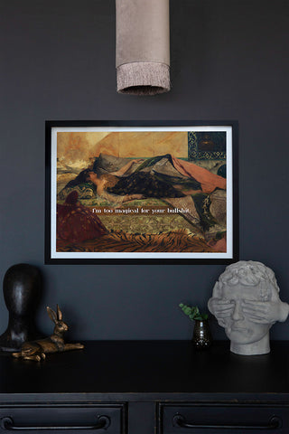 The Too Magical Art Print displayed on a dark wall above a sideboatd with various acessories on.