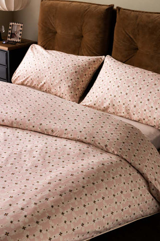 The Blush Pink Daisy Bedding Set with Piped Edge styled on a bed.