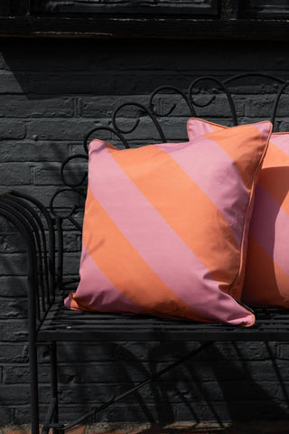 Lifestyle image of the Pink & Coral Stripe Outdoor Garden Cushion