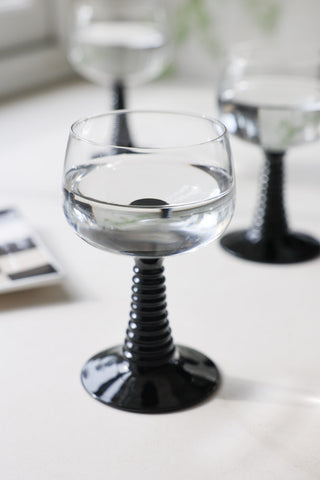 Lifestyle image of the 70s French Style Wine Glass In Black