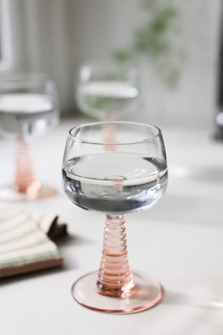 Lifestyle image of the 70s French Style Wine Glass In Pink