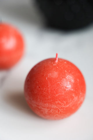 Close-up image of the Unique Ball Candle In Rust Orange