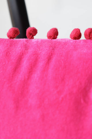 Detail image of the Hot Pink Pom Pom Velvet Cushion