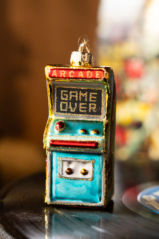 The Vintage Arcade Game Christmas Tree Decoration displayed on a record.
