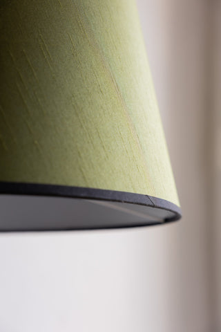 Close-up of the edge of the lampshade on the Vintage-Inspired Floor Lamp With Green Lampshade.
