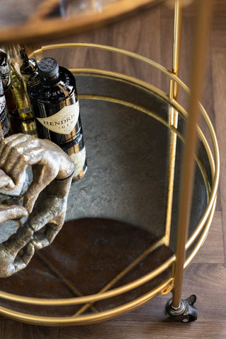 The bottom shelf of the Vintage Palms Gold Mirrored Drinks Trolley.