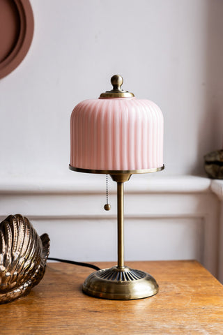 The Vintage Pink Fluted Glass Table Lamp shown with the light off against neutral walls. 