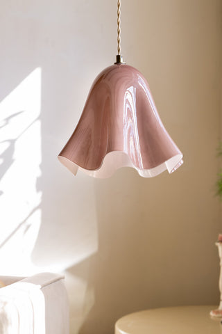 The Blush Wavy Glass Pendant Light shown against neutral white walls, with the light switched off. 
