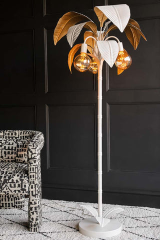 Image of the White Palm Tree Floor Lamp on rug with black background