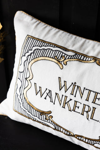 Decorative pillow with 'Winter Wankerl' text on a white background