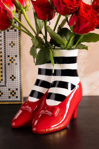 The Wizard of Oz 'Wicked Witch' Shoe Vase shown with red roses. 