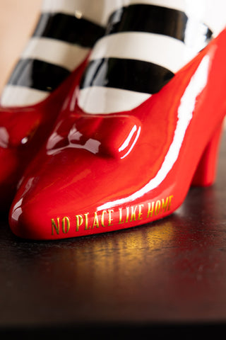 A close-up of the "No place like home" text written on the side of the shoes on the Wizard of Oz 'Wicked Witch' Shoe Vase. 