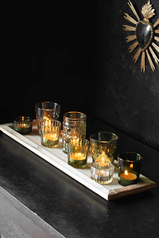 Lifestyle image of the Wooden Tray With Green Glass Candle Holder Votives