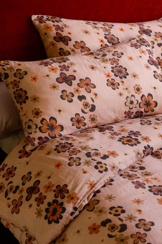 Woodstock Floral Cotton Muslin Bedding Set, showing a close up of the retro floral pattern. 